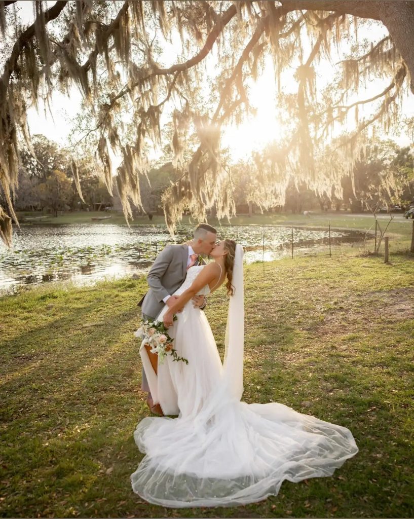 The Barn at Crescent Lake rustic barn wedding reception with crystal chandeliers and oak trees in Odessa, Florida