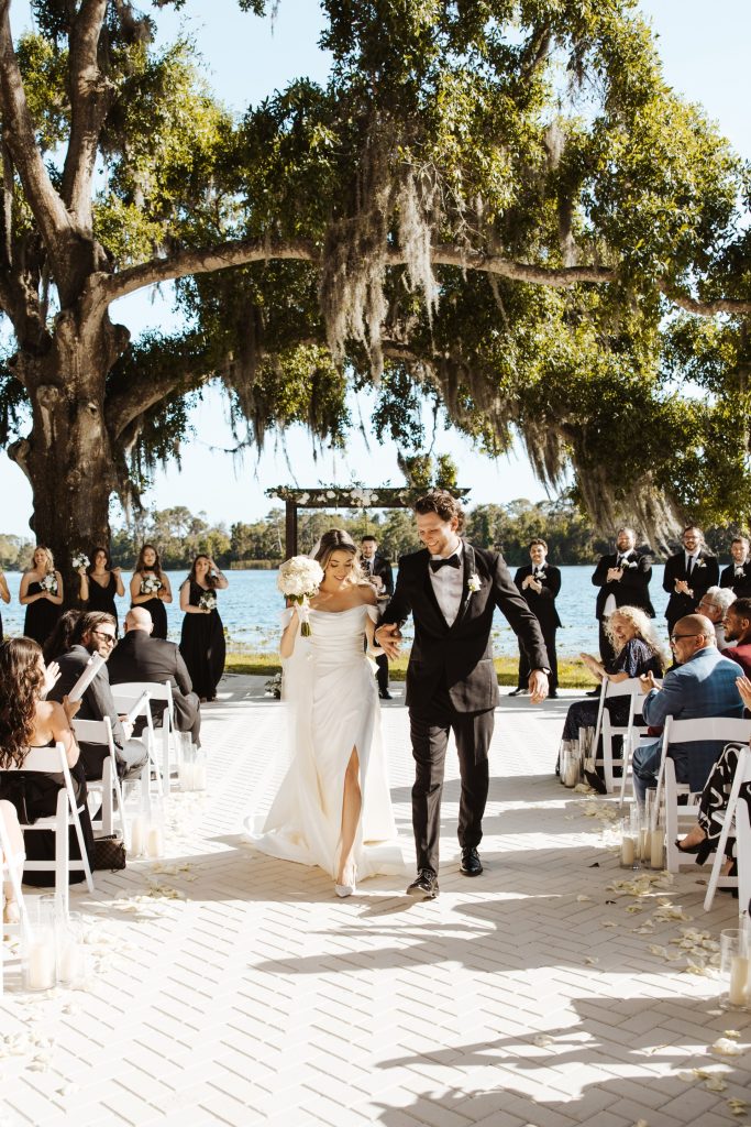 Interior of The Barn at Crescent Lake — rustic lakefront wedding venue near Wesley Chapel FL — featuring chandeliers and warm lighting